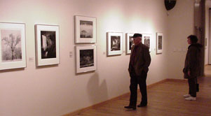 visitors in the gallery enjoy the Ansel Adams photos on exhibit