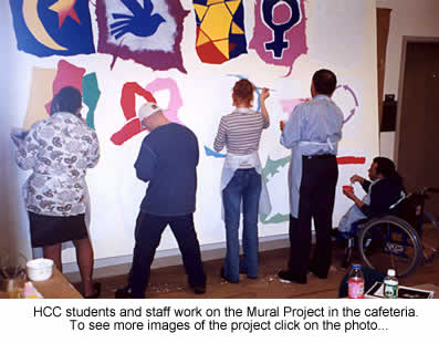 students and staff at work on the mural